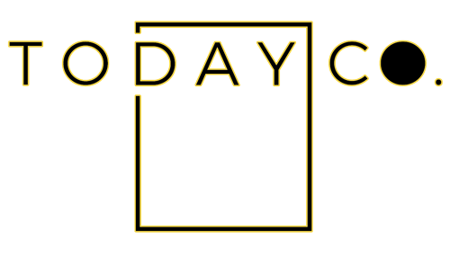 The Today Co. logo comprises a rectangle with solid black lines. The word 'TO' sits outside the rectangle to the top left and the word 'CO.' sits outside the rectangle to the top right. The word 'DAY' sits inside the top third of the rectangle, giving the impression of a calendar or planner. There is a gap in the second vertical line of the rectangle with the words 'let's begin' in gold cursive font. The 'o' in Co. is solid black followed by a full stop’.